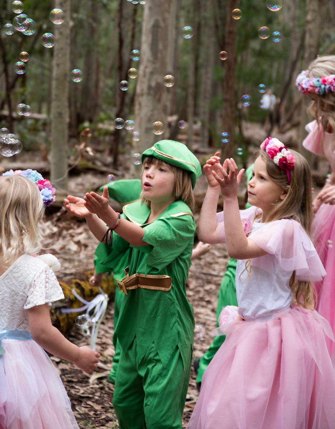 Pixies and fairy children playing with bubbles at party